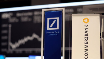 Banners of Deutsche Bank and Commerzbank are pictured in front of the German DAX in Frankfurt