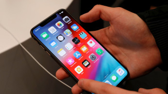 A customer tests a smartphone during the launch of the new iPhone XS and XS Max sales at a shop in Moscow, Russia