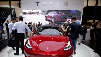 FILE PHOTO: A Tesla Model 3 car is displayed during a media preview at the Auto China 2018 motor show in Beijing