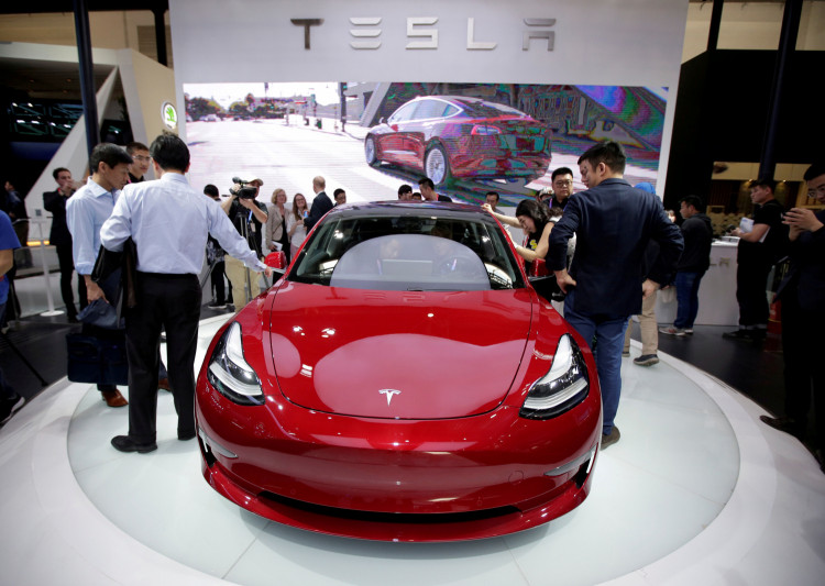 FILE PHOTO: A Tesla Model 3 car is displayed during a media preview at the Auto China 2018 motor show in Beijing
