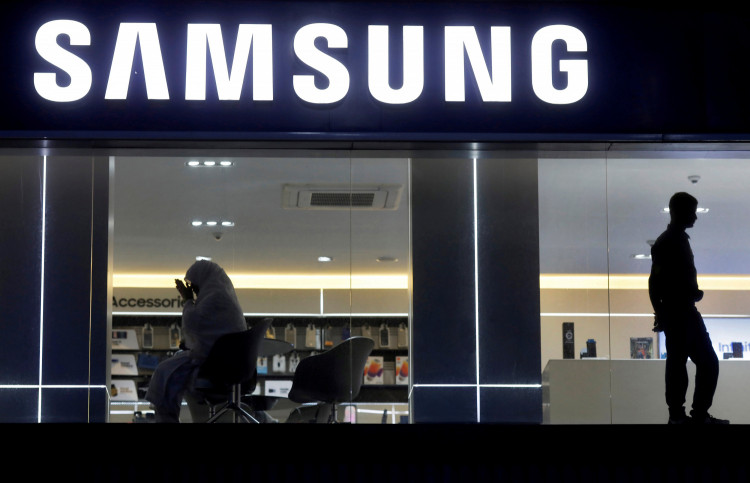 A customer prays inside a Samsung showroom in New Delhi
