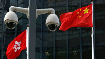 Chinese national flag and Hong Kong flag fly outside government headquarters