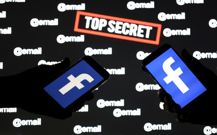 Persons hold smartphones with the Facebook logo in front of displayed "top secret" and "email" words in this picture illustration