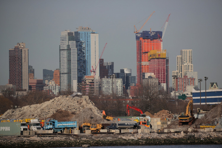 Cranes are seen among construction equipment in the Brooklyn borough of New York City