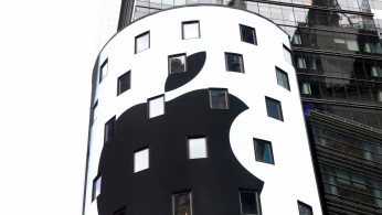 An electronic screen displays the Apple Inc. logo on the exterior of the Nasdaq Market Site following the close of the day's trading session in New York City