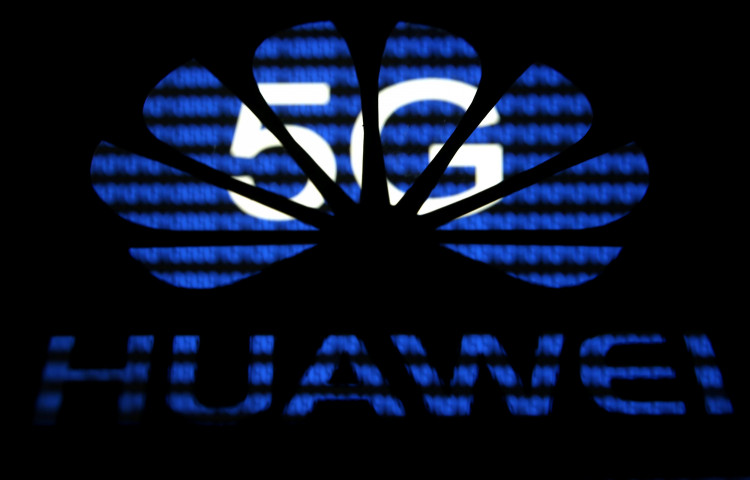 A 3-D printed Huawei logo is seen in front of displayed 5G words in this illustration