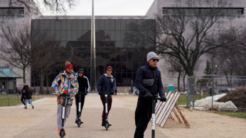People ride on scooters outside the Smithsonian Air and Space Museum in Washington