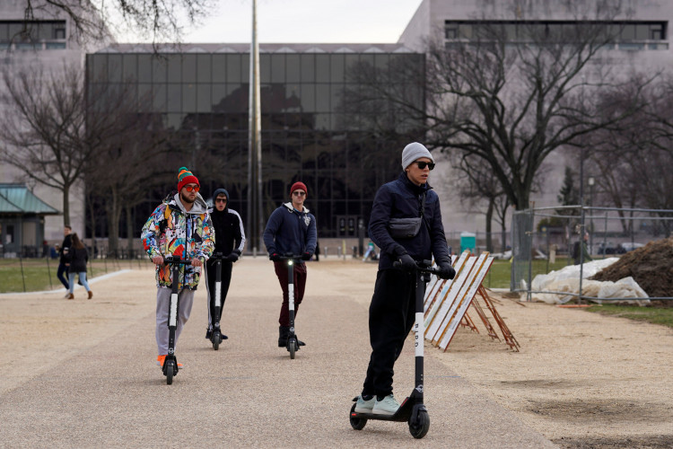 People ride on scooters outside the Smithsonian Air and Space Museum in Washington