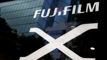 Fujifilm's company logo (top) is seen at its exhibition hall nearby the headquarters of Fujifilm Holdings Corp in Tokyo, Japan.