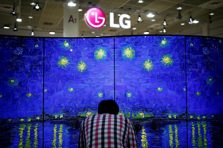 A man examines LG Electronics' double-faced and curved OLED TV during Korea Electronics Show 2016 in Seoul