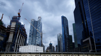  Office workers walk to the train station during evening rush hour in the financial district of Singapore