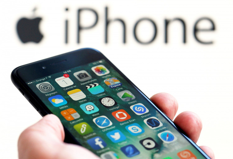 An Apple iPhone 7 and the company logo are seen in this illustration picture taken in Bordeaux