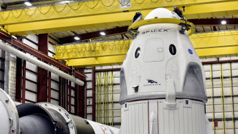 The Dragon crew capsule sits in the SpaceX hangar at Launch Complex 39-A, where the space ship and Falcon 9 booster rocket are being prepared for a January 2019 launch at Cape Canaveral