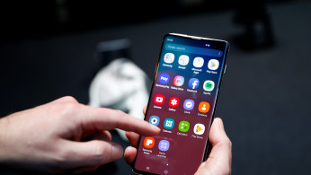 A journalist uses the new Samsung Galaxy S10 smartphone at a press event in London