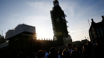 People walk across Westminster Bridge in central London