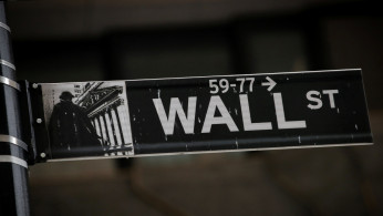 A Wall St. street sign is seen near the New York Stock Exchange (NYSE)