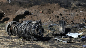 Engine parts are seen at the scene of the Ethiopian Airlines Flight ET 302 plane crash, near the town of Bishoftu, southeast of Addis Ababa, Ethiopia