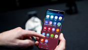 A journalist uses the new Samsung Galaxy S10 smartphone at a press event in London