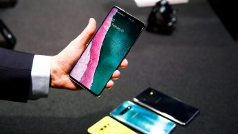 A journalist holds the new Samsung Galaxy S10 smartphone at a press event in London