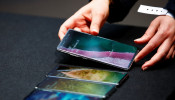 A Samsung employee arranges the new Samsung Galaxy S10e, S10, S10+ and the Samsung Galaxy S10 5G smartphones at a press event in London