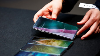 A Samsung employee arranges the new Samsung Galaxy S10e, S10, S10+ and the Samsung Galaxy S10 5G smartphones at a press event in London