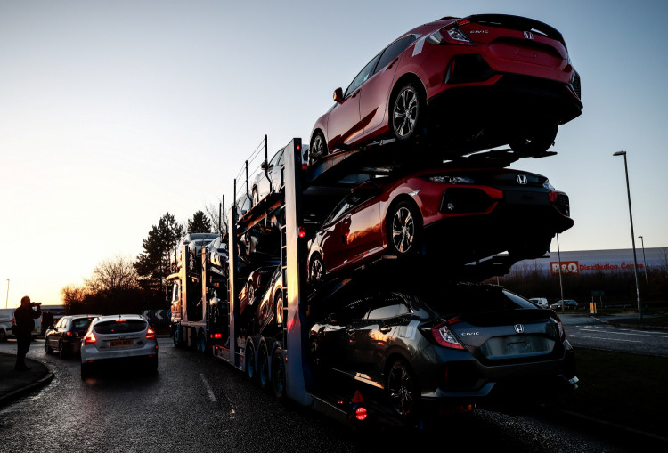 A lorry with car carrier trailer leaves the Honda car plant in Swindon