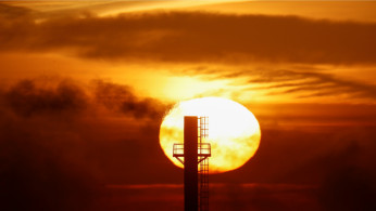 The sun rises behind a chimney in Minsk, Belarus, March 4, 2019. 