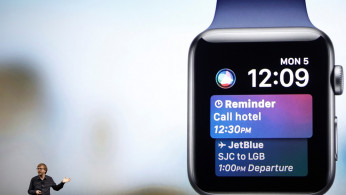 Kevin Lynch speaks near a projection of an Apple Watch during the company's annual world wide developer conference in San Jose