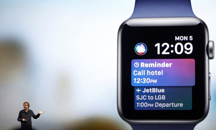 Kevin Lynch speaks near a projection of an Apple Watch during the company's annual world wide developer conference in San Jose