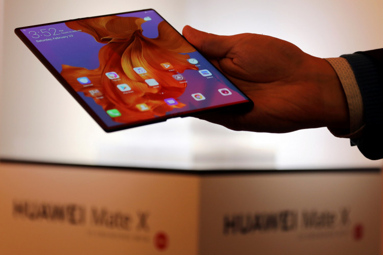A member of Huawei staff shows the new Huawei Mate X device during a pre-briefing display ahead of the Mobile World Congress in Barcelona