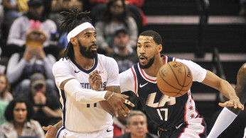 Memphis Grizzlies guard Mike Conley (11) passes the ball around LA Clippers guard Garrett Temple (17) 