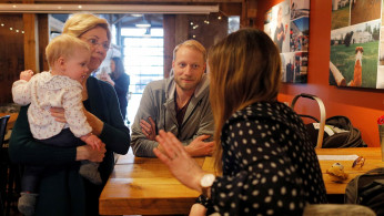 Democratic 2020 U.S. presidential candidate Warren holds a baby in North Hampton.