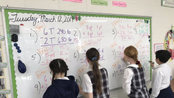 Students in 5H math class converting measurements. 