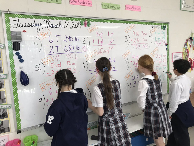 Students in 5H math class converting measurements. 