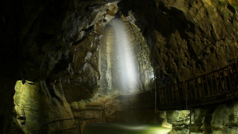 A waterfall is pictured at the Grotte aux Fees (Fairy Cave), where since 1864 visitors can see an underground river come out in the rocks 500 meters inside the mountain, in St-Maurice, Switzerland, March 19, 2019. Picture taken with a long exposure. 