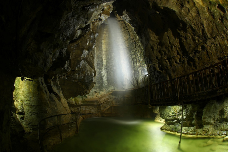 A waterfall is pictured at the Grotte aux Fees (Fairy Cave), where since 1864 visitors can see an underground river come out in the rocks 500 meters inside the mountain, in St-Maurice, Switzerland, March 19, 2019. Picture taken with a long exposure. 