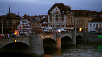 Carnival revellers march during the traditional Morgenstreich parade, crossing a bridge over the Rhine river, in Basel, Switzerland March 11, 2019. 