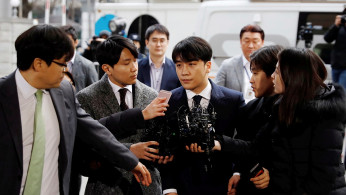Seungri, a member of South Korean K-pop band Big Bang, arrives to be questioned over a sex bribery case at the Seoul Metropolitan Police Agency in Seoul, South Korea, March 14, 2019. 