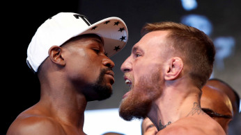Undefeated boxer Floyd Mayweather Jr. (L) of the U.S. and UFC lightweight champion Conor McGregor of Ireland