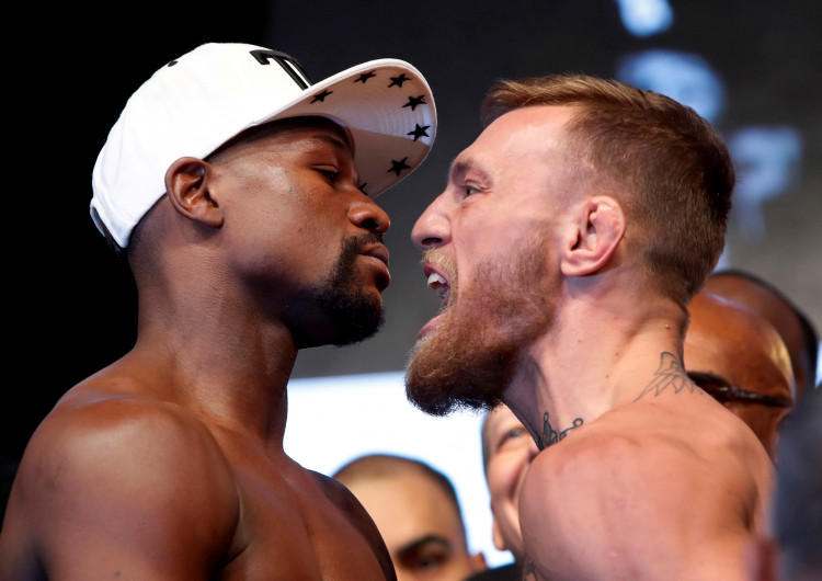 Undefeated boxer Floyd Mayweather Jr. (L) of the U.S. and UFC lightweight champion Conor McGregor of Ireland