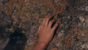 Person Touching a Rock with Molds