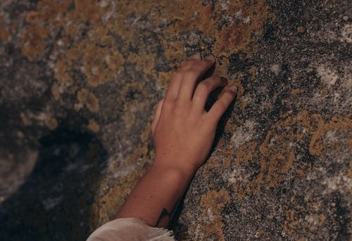 Person Touching a Rock with Molds