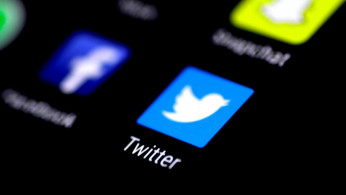 The Twitter application is seen on a phone screen