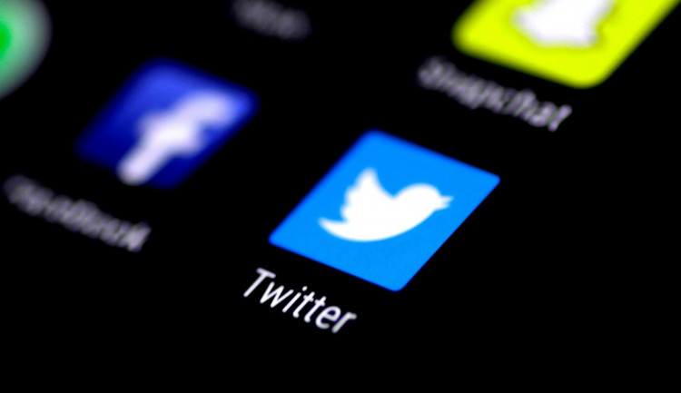 The Twitter application is seen on a phone screen