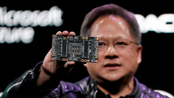 Jensen Huang, CEO of Nvidia, shows the NVIDIA Volta GPU computing platform at his keynote address at CES in Las Vegas