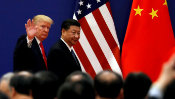 FILE PHOTO: U.S. President Donald Trump and China's President Xi Jinping meet business leaders at the Great Hall of the People in Beijing