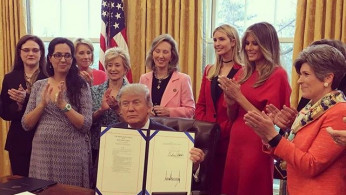 Melania and Ivanka Trump featured in the background at the President Trump’s signing March 2018 of the STEM bills in the Oval Office.
