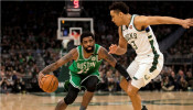 Boston Celtics guard Kyrie Irving (11) drives for the basket against Milwaukee Bucks guard Malcolm Brogdon (13) 