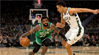 Boston Celtics guard Kyrie Irving (11) drives for the basket against Milwaukee Bucks guard Malcolm Brogdon (13) 
