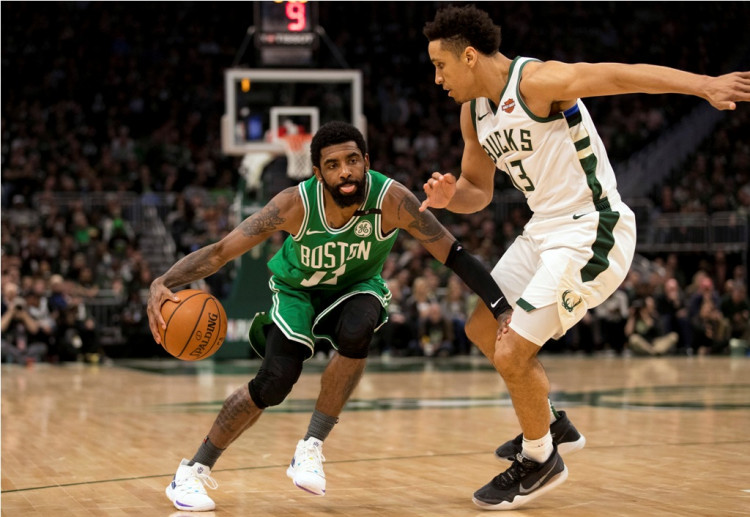 Boston Celtics guard Kyrie Irving (11) drives for the basket against Milwaukee Bucks guard Malcolm Brogdon (13) 